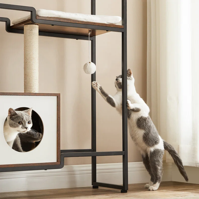 Cat playing with a ball on a cat tree in a home setting